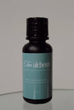 Black bottle with a teal label on a reflective surface