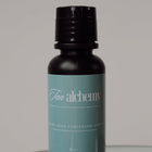 Bottle of 'Fun Alchemy' product on a reflective surface with a gray background