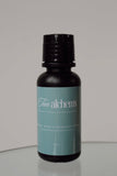 Bottle of 'Fun Alchemy' product on a reflective surface with a gray background