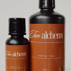 Two bottles of Tan Alchemy Rapid Tan on a white background