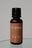 Tan alchemy bottle on a reflective surface with a neutral background