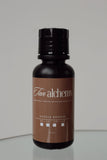 Tan alchemy bottle on a reflective surface with a neutral background