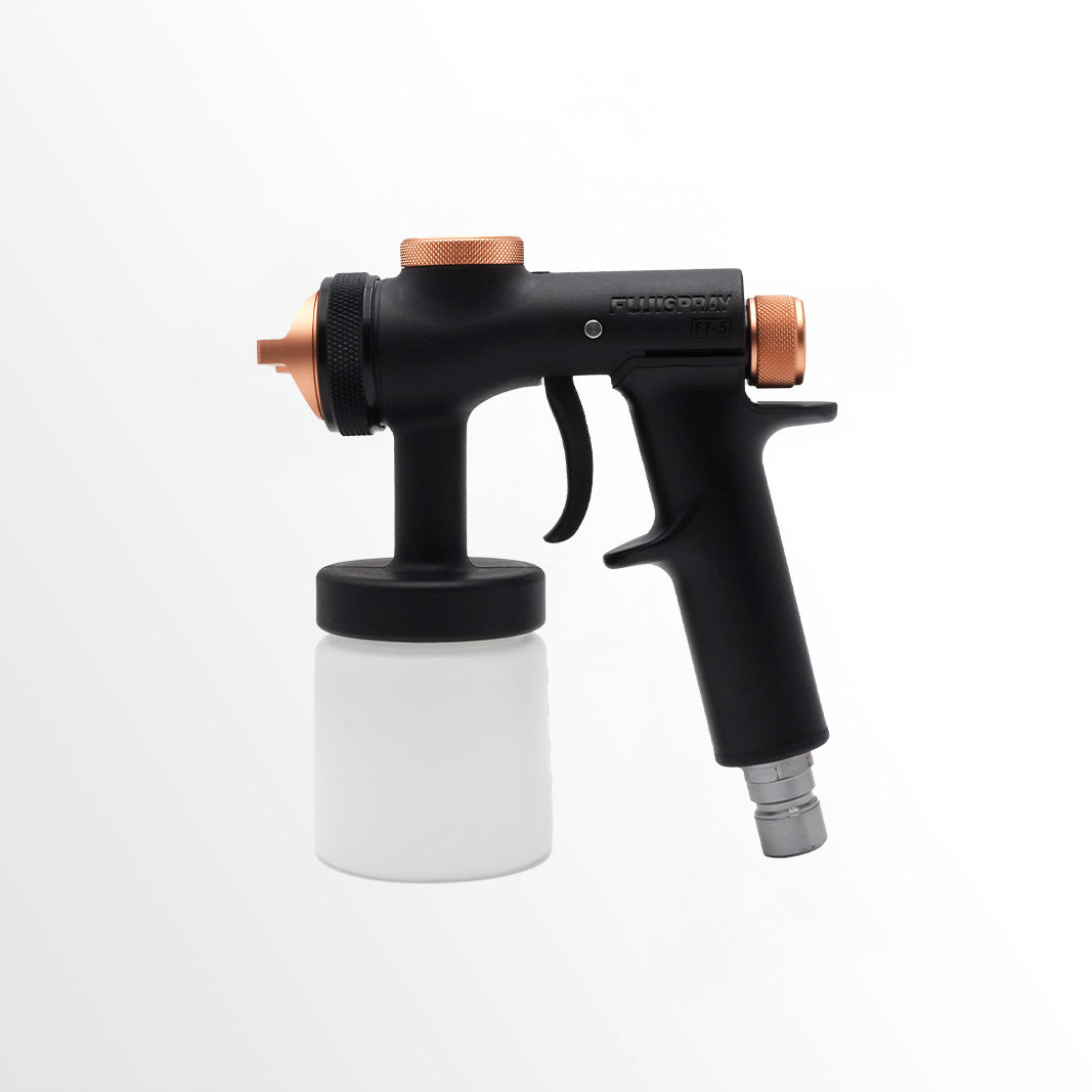 Black and copper spray gun with a white container on a white background