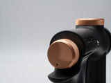 Close-up of a black and rose gold device on a gray background