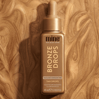 Bronze Drops tan drop bottle on a wooden background