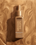 Bronze Drops tan drop bottle on a wooden background