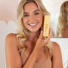 Happy woman with MineTan Wonder Tan Bronzing Face Serum