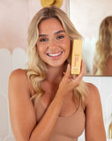Happy woman with MineTan Wonder Tan Bronzing Face Serum