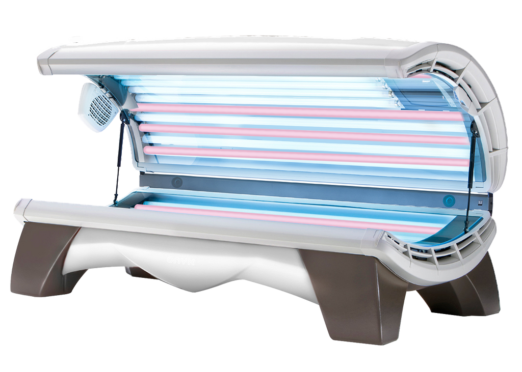 A commercial tanning bed with multiple high-output lamps arranged for even tanning coverage, featuring a mix of UV and red light lamps.