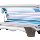 A commercial tanning bed with multiple high-output lamps arranged for even tanning coverage, featuring a mix of UV and red light lamps.