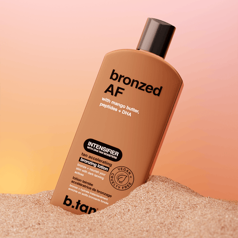 Bottle of 'broned AF' tan accelerating bronzing lotion by b.tan on a sand and gradient background.