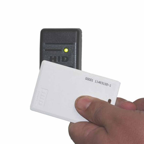 Hand holding card with a HID reader on a white background