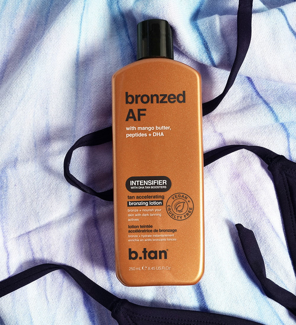 B.tan bronzed AF tan accelerating bronzing lotion bottle on a textured white background