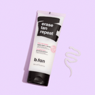 Tube of b.tan 'erase tan repeat' body wash and scrub on a light purple background