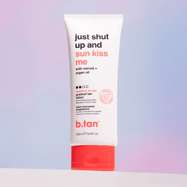 Tube of b.tan tanning lotion with red and white design on a gradient background