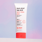 Tube of b.tan tanning lotion with red and white design on a gradient background