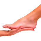 Close-up of a foot and hand on a white background