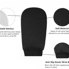 Black tanning mitt with text highlighting solid stitches, soft material, and anti-slip elastic wrist band on a white background.