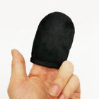 Black finger sleeve on a person's finger against a white background