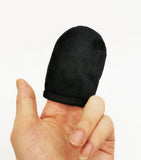 Black finger sleeve on a person's finger against a white background