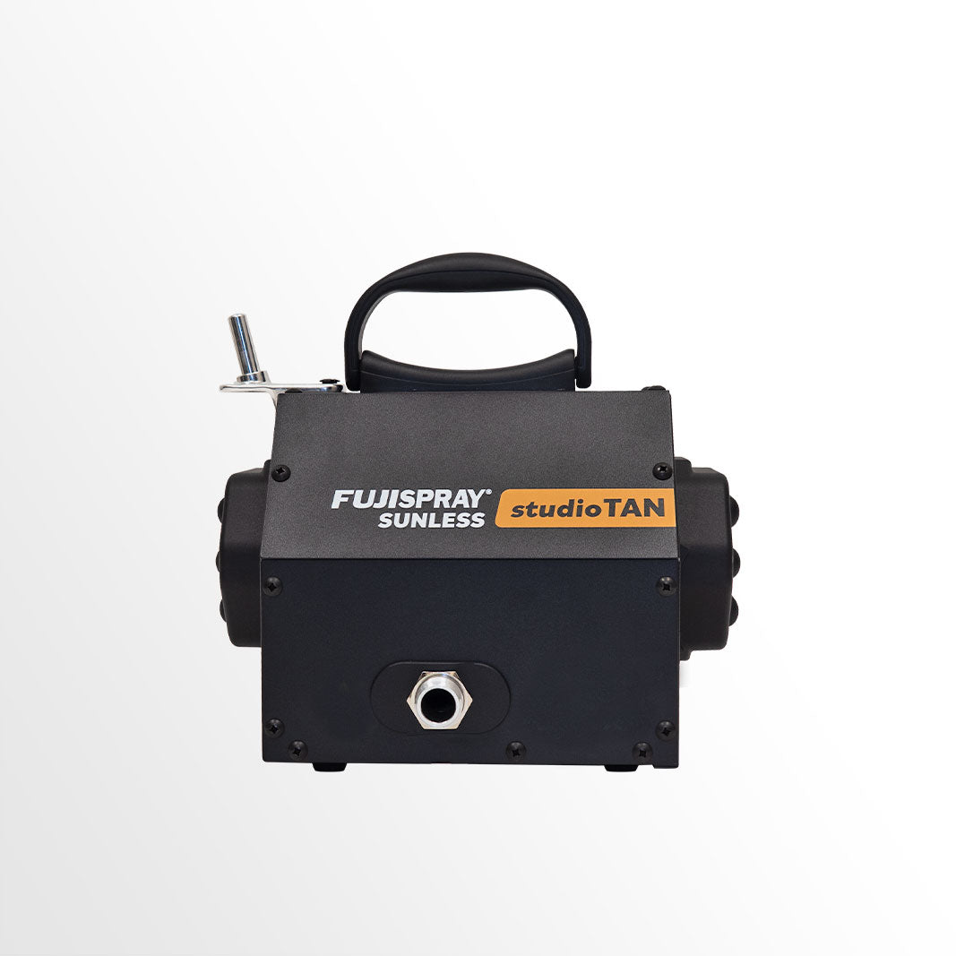 Black tanning machine with 'FujiSpray Sunless studioTAN' branding on a white background