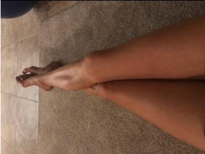 Close-up of a person's feet on a tiled floor
