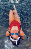 Person in a red swimsuit and sunglasses floating in water with '#Rapid' text above.